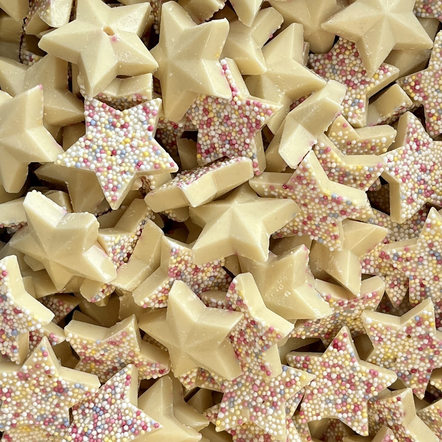 Close-up of white chocolate Snowie Stars with vibrant topping

