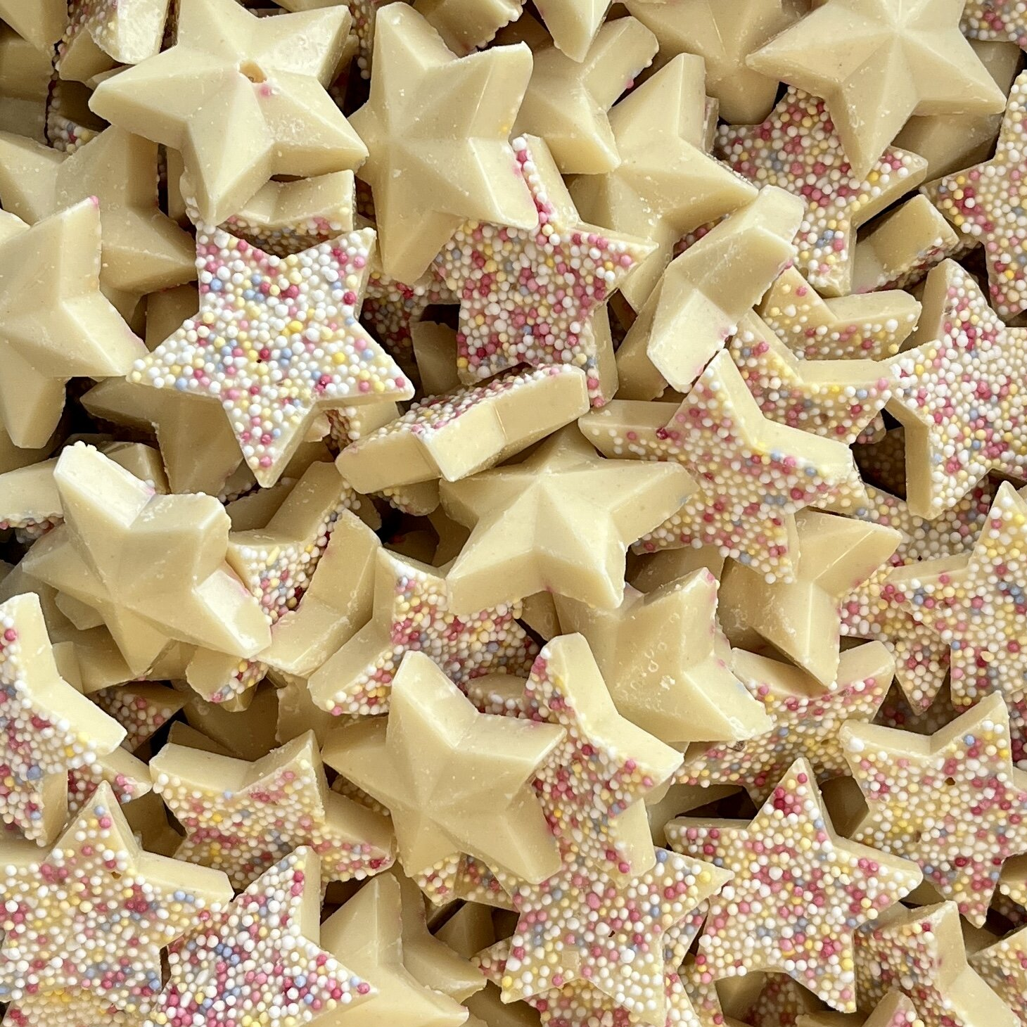 Close-up of white chocolate Snowie Stars with vibrant topping

